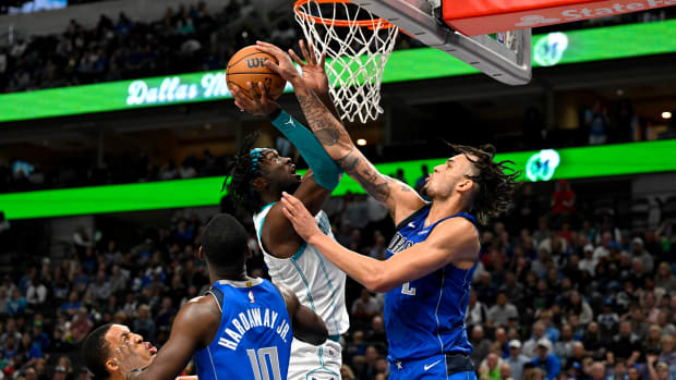 Dallas Mavericks rookie Dereck Lively II contests Charlotte Hornets' Mark Williams, who, like Lively, also played his college ball at Duke.